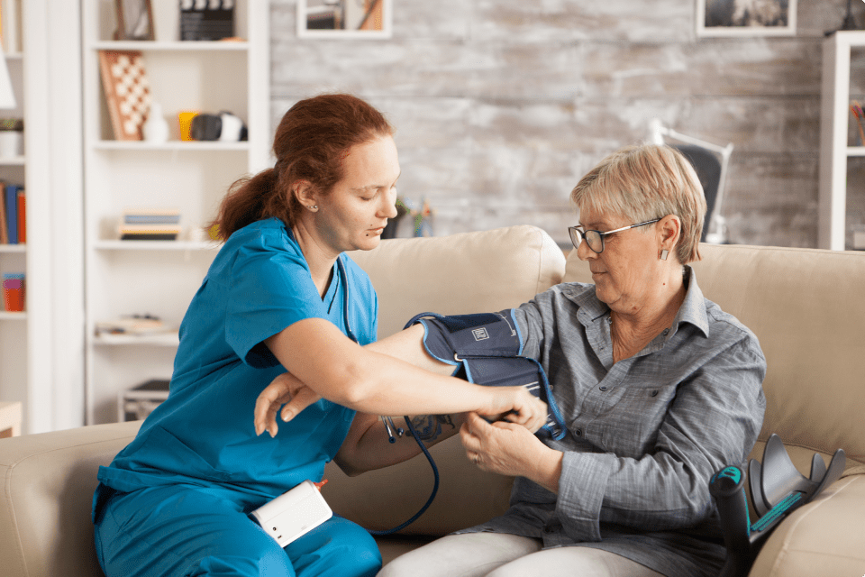 female-nurse-using-digital-blood-pressure-device-senior-woman-nursing-home 2